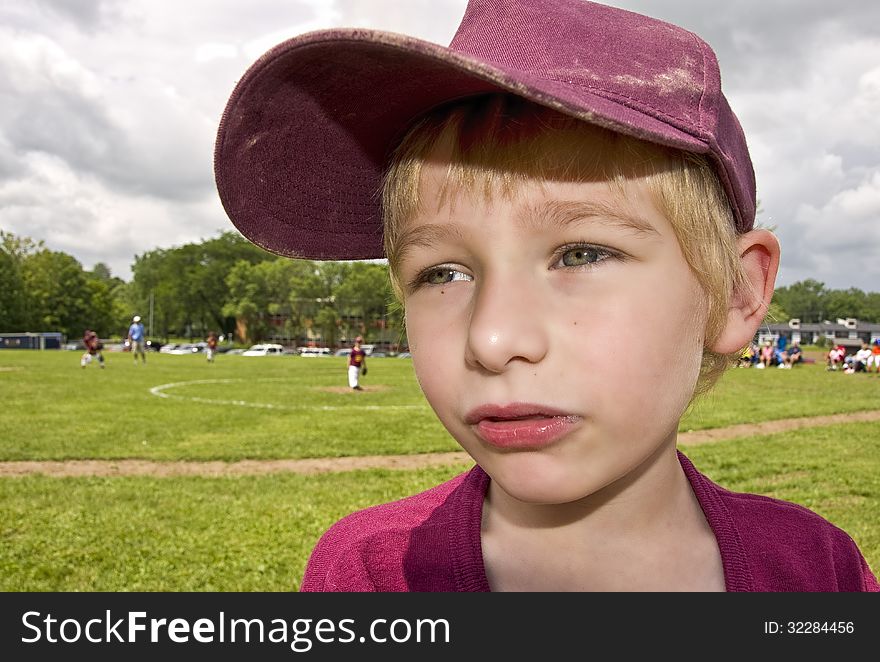 Close-up of young boy in baseball uniform at field. Close-up of young boy in baseball uniform at field