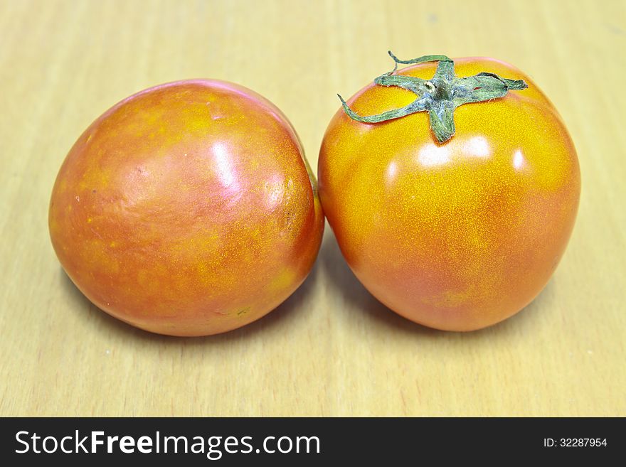 Tomatos on wood table background