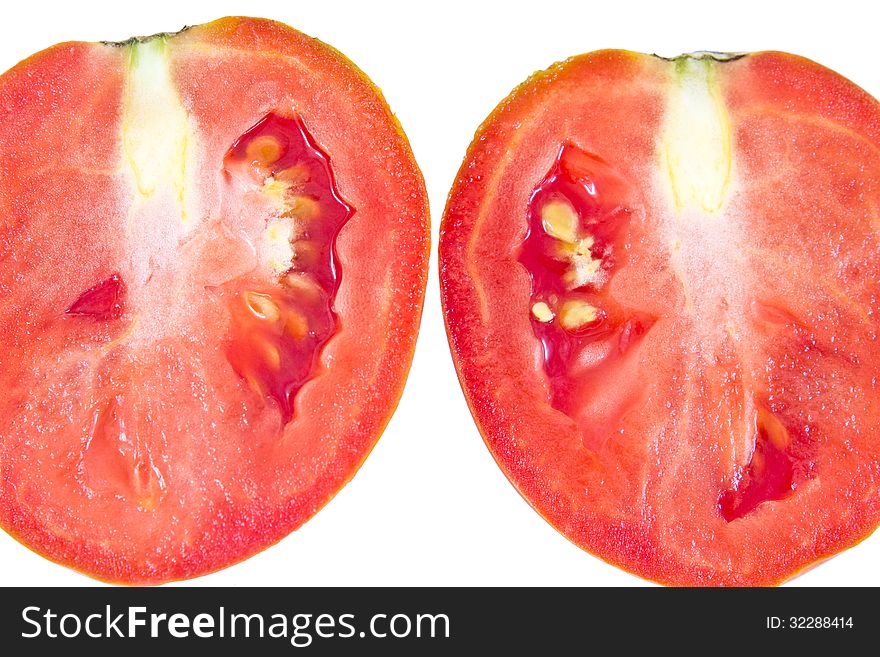 Cut of juicy tomato on a white background