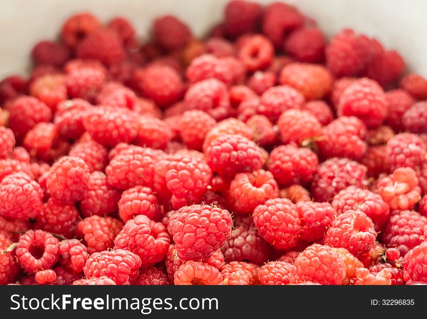 Sweet fresh raspberries closeup background. Selective focus. Sweet fresh raspberries closeup background. Selective focus