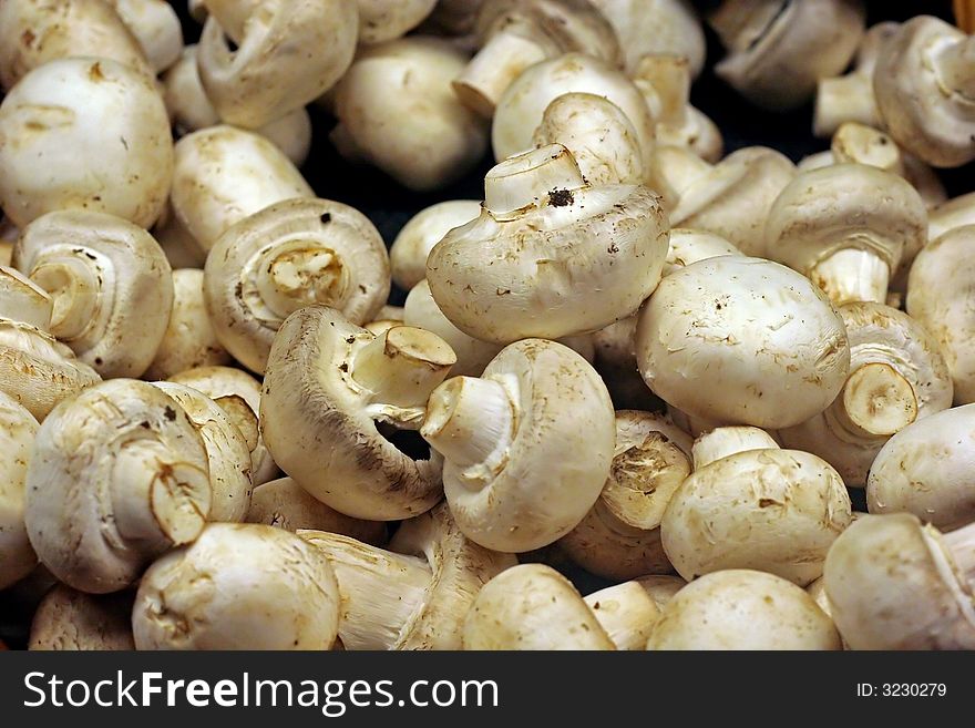 White button mushrooms for sale in a vegetable market