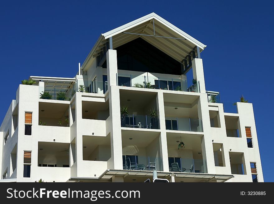 While holiday apartment building with blue sky as background. While holiday apartment building with blue sky as background