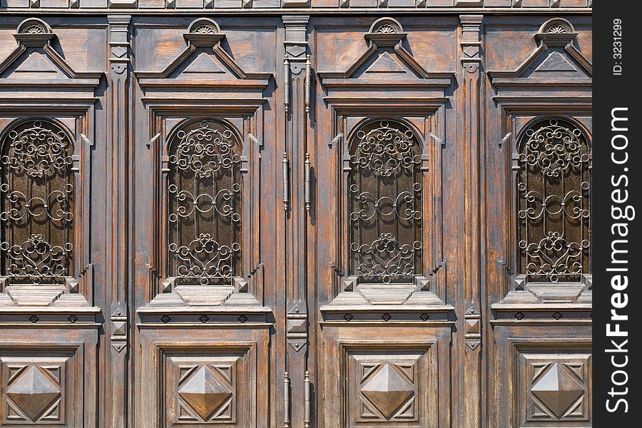 Old wooden doors with carvings and ornamented metal bars