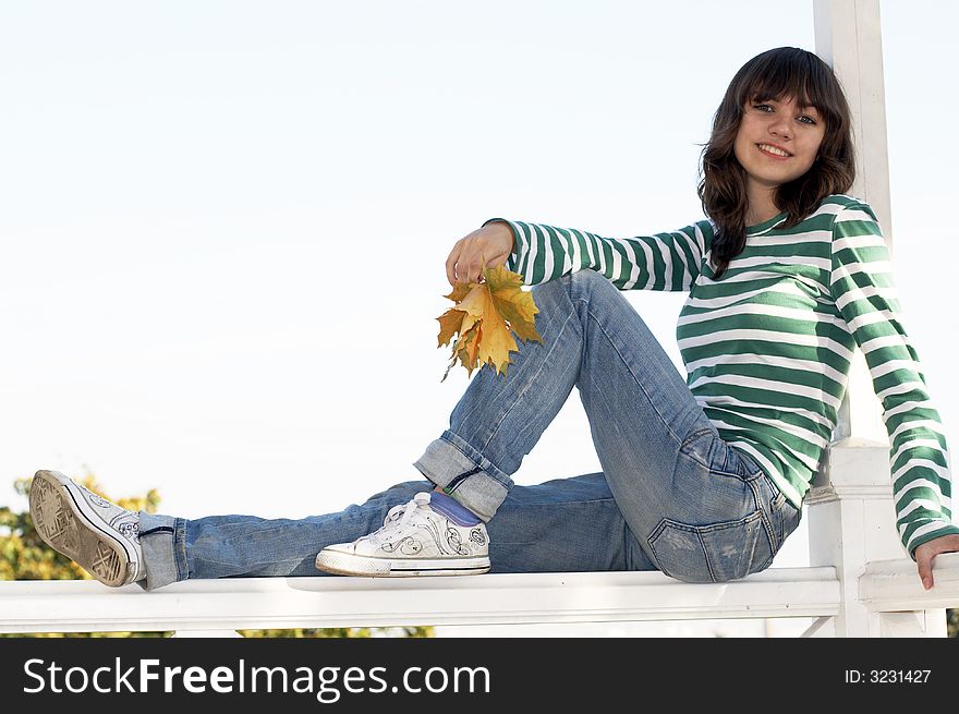 Girl holds autumn leafs