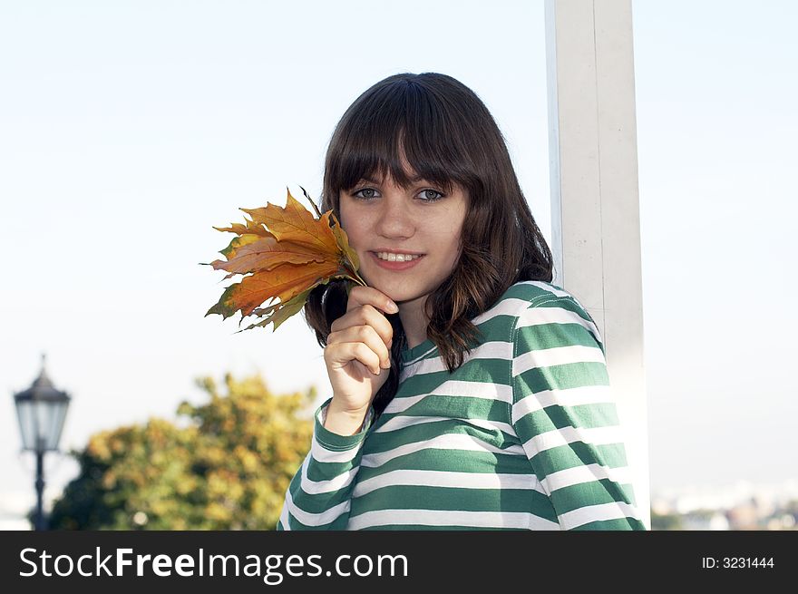 Girl holds autumn tree leafs. Girl holds autumn tree leafs