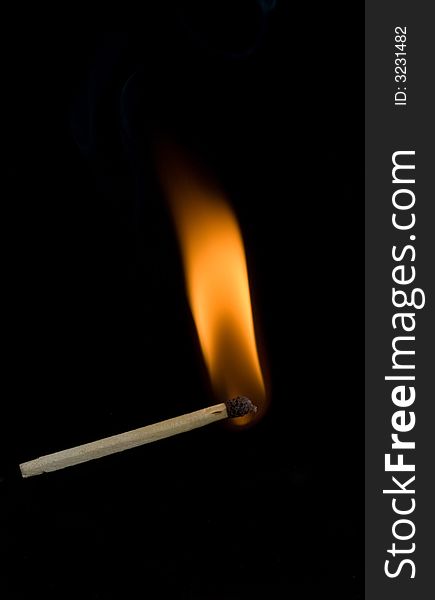 Burning match on black background. Burning match on black background