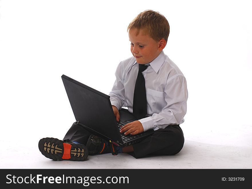 A boy with laptop isolated on white