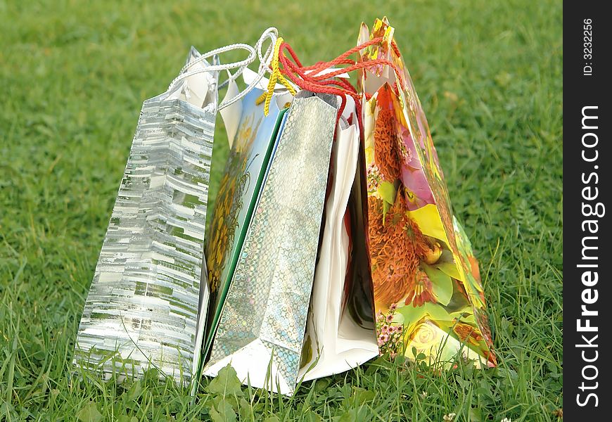 5 bags with gifts on the grass. 5 bags with gifts on the grass