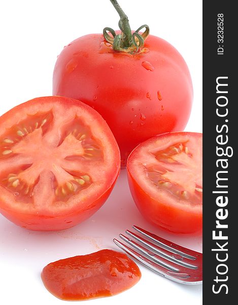 Tomatoes cut and fork with drops water