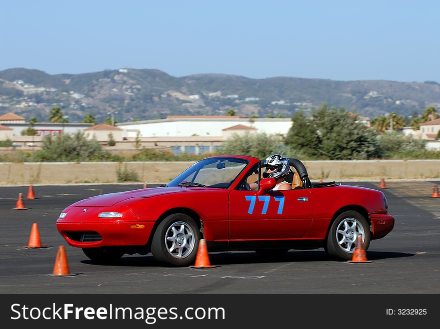 Older red sports car competing in autocross race. Older red sports car competing in autocross race