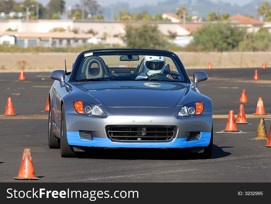 Grey japanese sports car competing in autocross race. Grey japanese sports car competing in autocross race