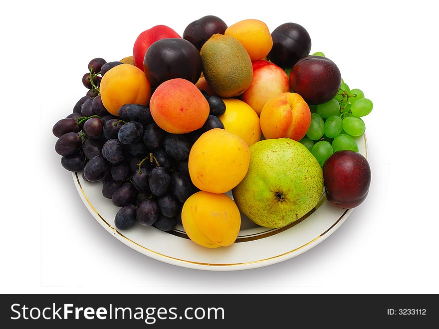 Many different colorful fruits on the plate (isolated with clipping path)