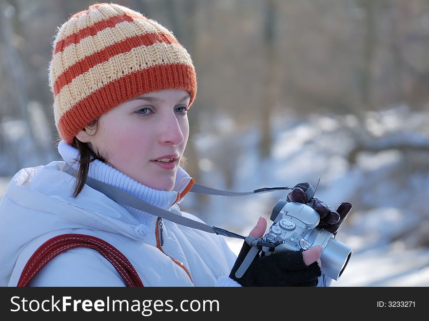 Young photographer on winter background