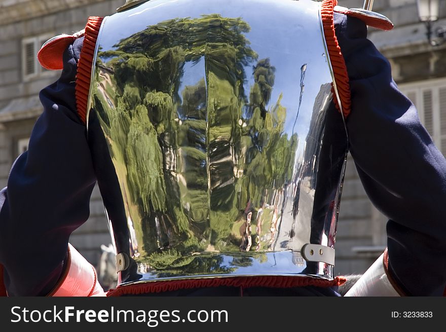 The reflection of the plaza oriente can be seen in the polished body armor of this Spanish royal guard in Madrid, Spain.