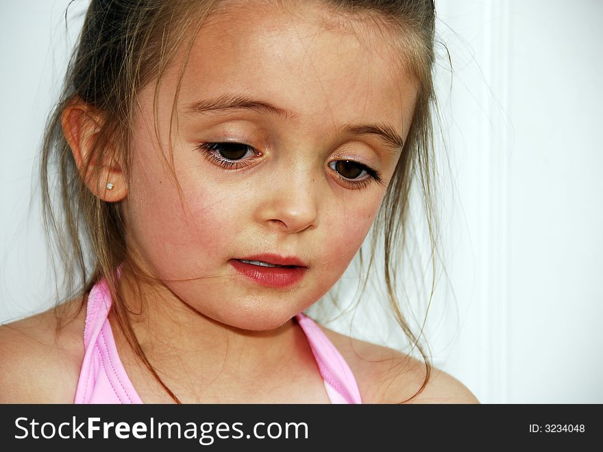 A brunette child looking very serious. A brunette child looking very serious.