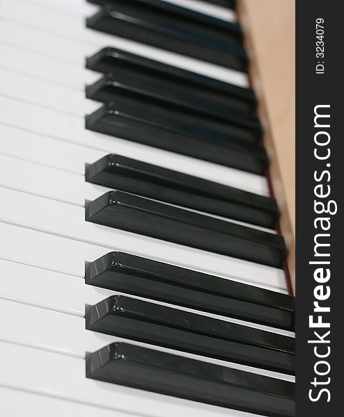 Angle shot of a piano keyboard showing black and white keys