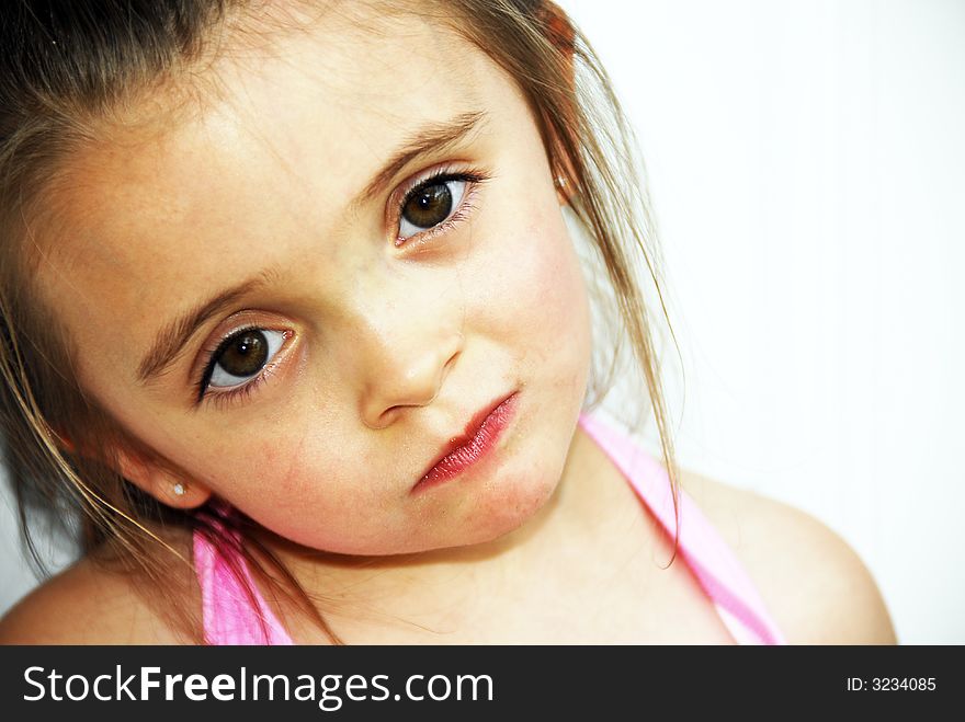 A brunette child looking very serious. A brunette child looking very serious.