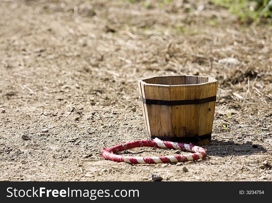 A competition ring lays next to a bucket. A competition ring lays next to a bucket