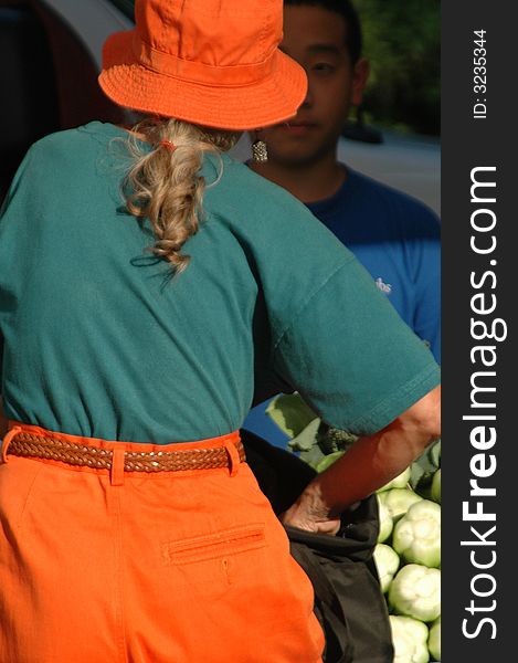 Shopper buying produce at an outdoor market. Shopper buying produce at an outdoor market.