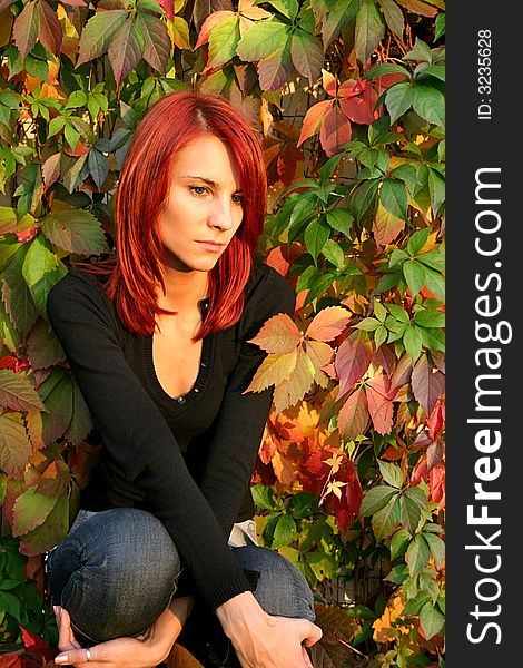 Girl with red hair nier the colored leaves