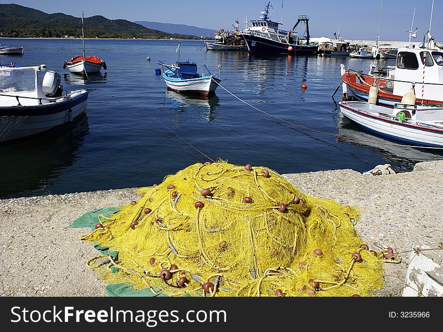 Yellow fishnet at the beach and boats
