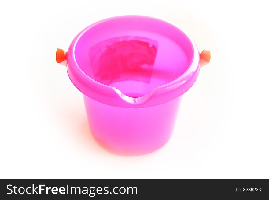 On a photo children's pink bucket. On a photo children's pink bucket
