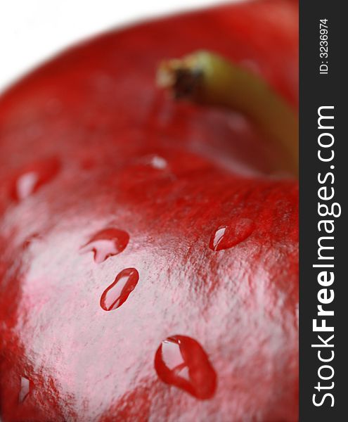 Red apple covered with water droplets . Red apple covered with water droplets .