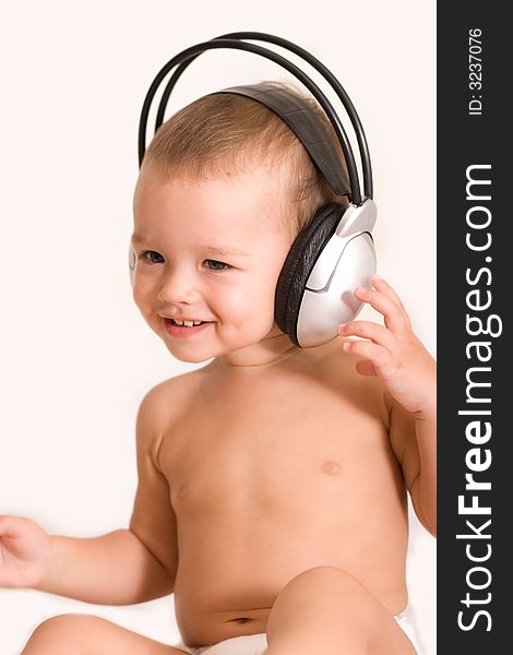 Little child listen to headphones. Little child listen to headphones