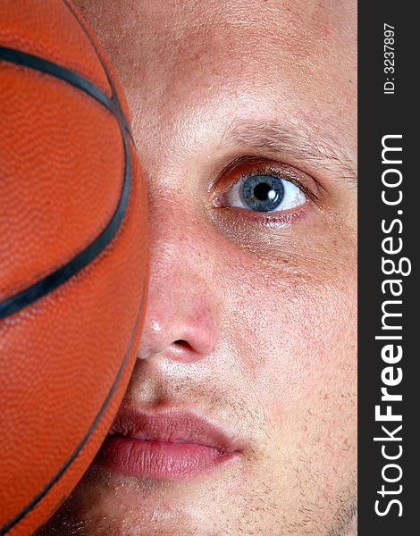 A closeup of a basketball player with half of his face covered with a ball!. A closeup of a basketball player with half of his face covered with a ball!