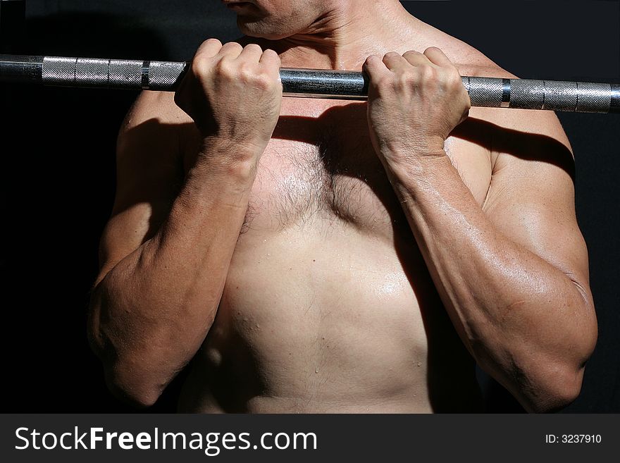 Man in the gymnasium with iron bar