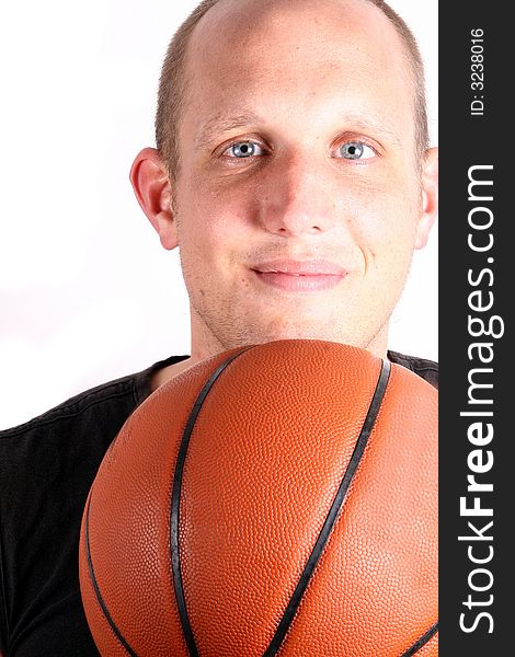 Close up of a young man with bright blue eyes and a basketball! Isolated over white!. Close up of a young man with bright blue eyes and a basketball! Isolated over white!