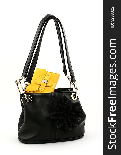 Black handbag with handles up and yellow wallet on a white background. Black handbag with handles up and yellow wallet on a white background