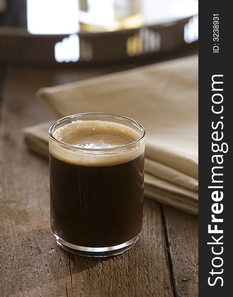 Glass of dark coffee with crema. Glass of dark coffee with crema
