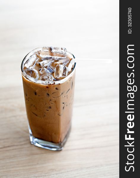 Glass of ice coffee on table