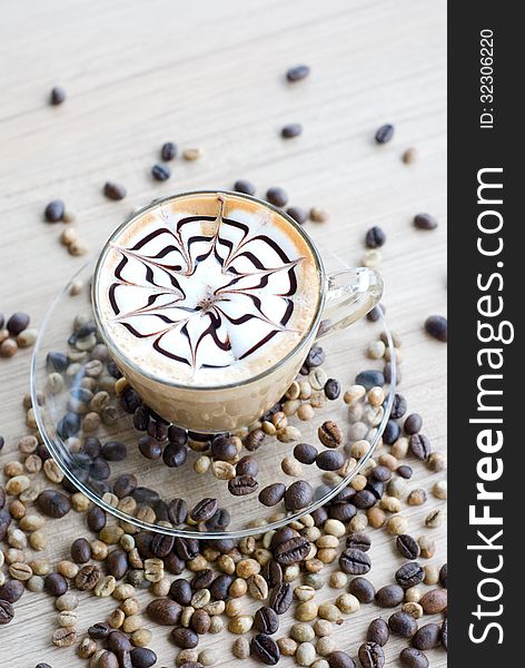 Verticle latte art with coffee beans on table. Verticle latte art with coffee beans on table