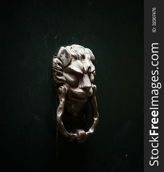 Lion ancient doorknocker on door