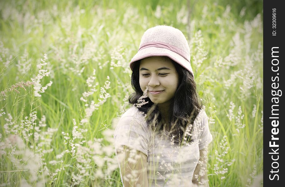 Young woman on the meadow with white flowers on a warm summer da