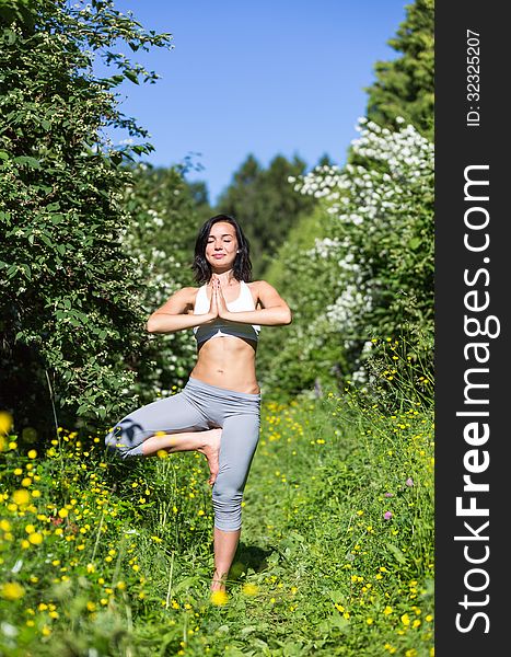 Girl doing yoga outdoor with closed eyes. Girl doing yoga outdoor with closed eyes