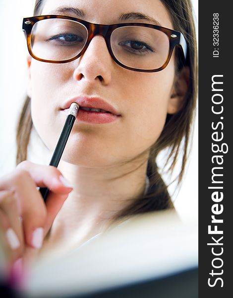 Young woman taking notes at home