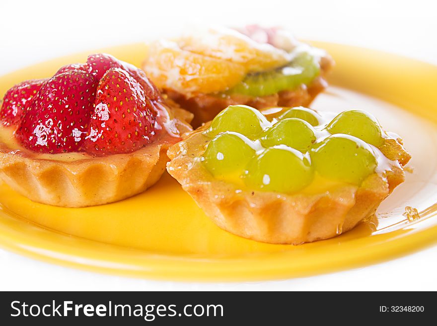 Glazed fruit cakes on plate