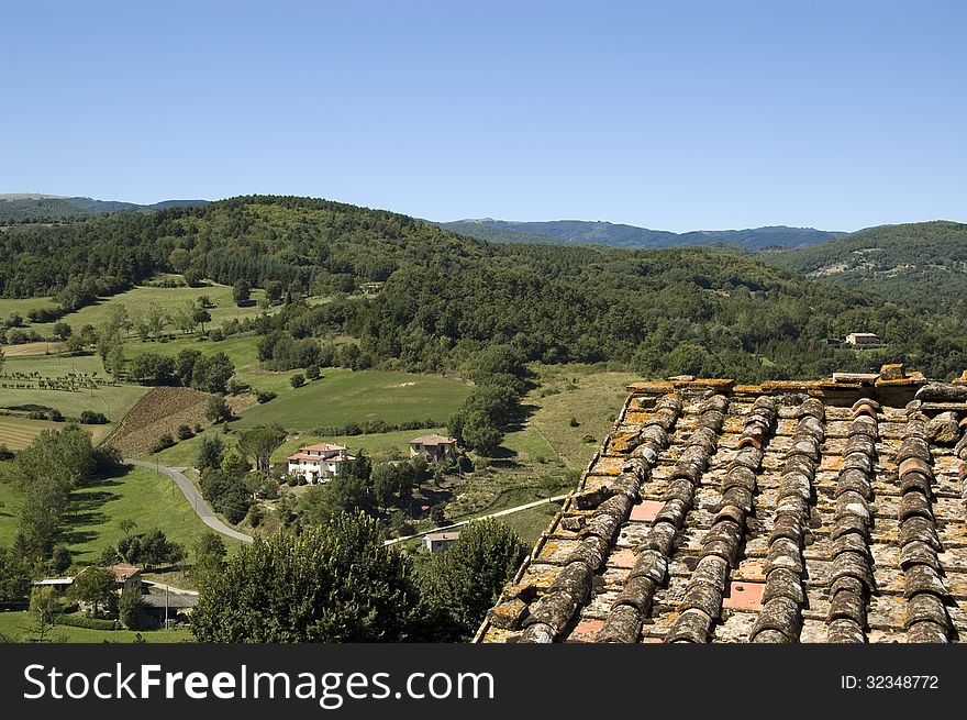 View on Tuscan landscape with roof on the foreground