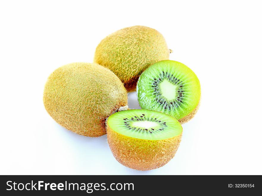 Ripe kiwi fruit sliced on a white background