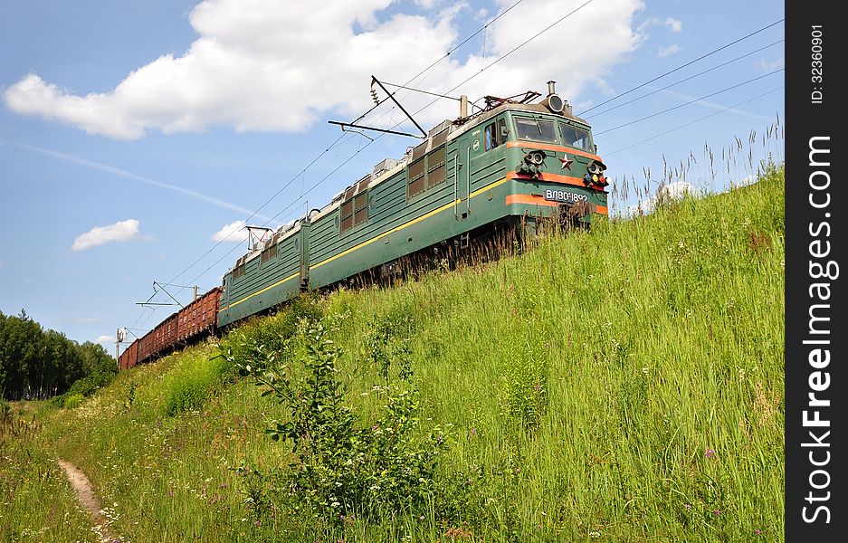 Summer landscape with an electric train.