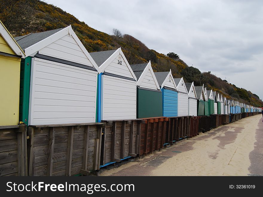 Row of colorful beach-huts on promenade in Bournemouth, England. Row of colorful beach-huts on promenade in Bournemouth, England.