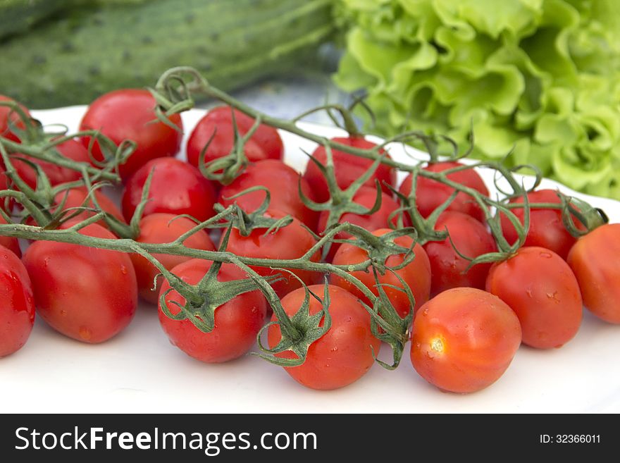 Cherry tomatoes cucumber salad on the tablecloth