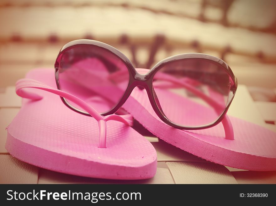 Fashionable Women S Sunglasses And Pink Flip Flops