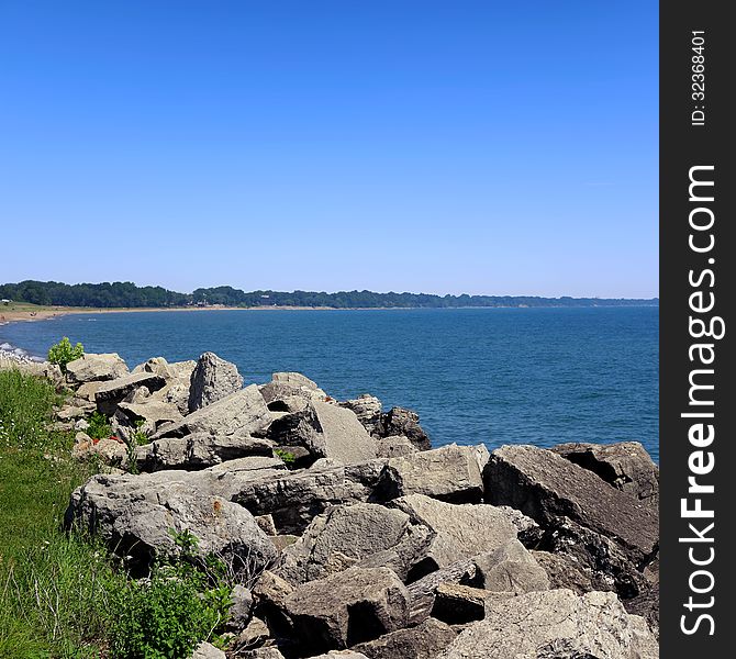 Summer landscape with lake Michigan, blue sky and rock shore. Summer landscape with lake Michigan, blue sky and rock shore