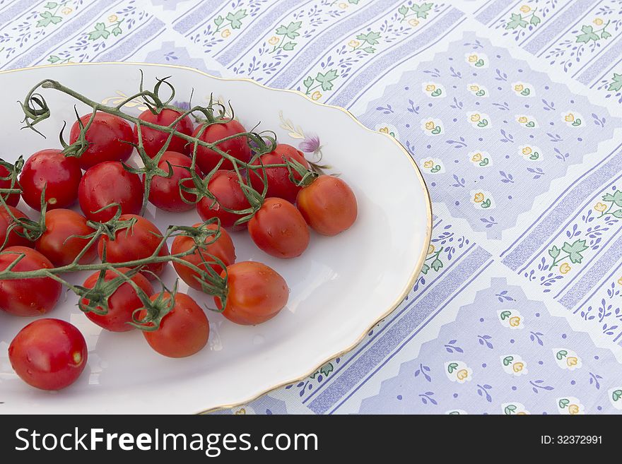Cherry tomatoes plate tablecloth blue striped flower picture red and green agriculture