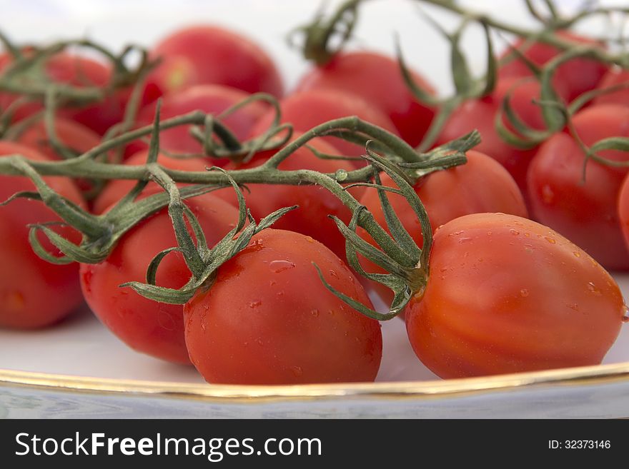 Cherry tomatoes plate tablecloth blue striped flower picture red and green agriculture