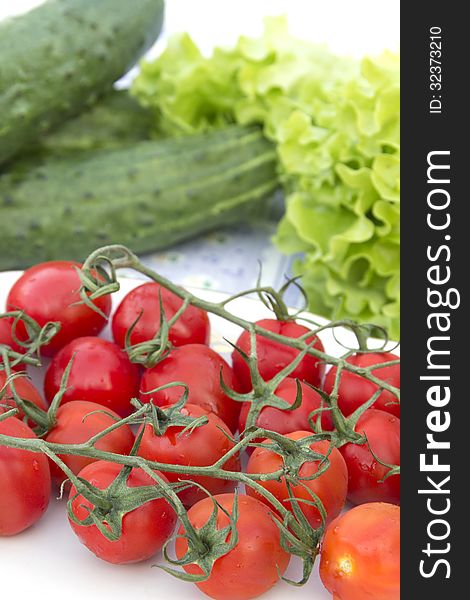 Cherry tomatoes cucumber salad on the tablecloth blue striped flower picture red and green agriculture